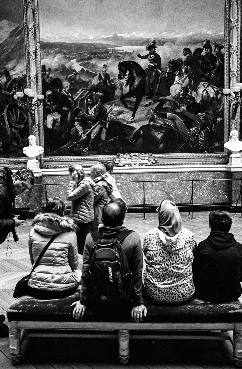 #10 four people looking at paint.