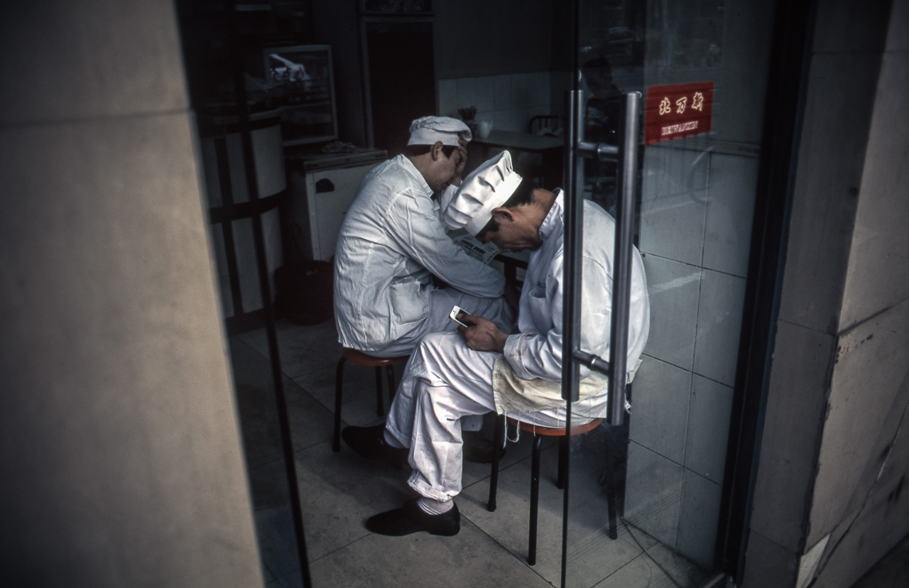#15 Two cooks on lunch break in the french concession. People REALLY like their smartphones in Shanghai.