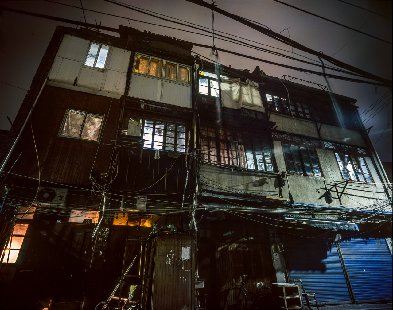 #48 Detail on the Front Row - this building should house around ten families - the boarded up area on the right is a fabric shop during the day.