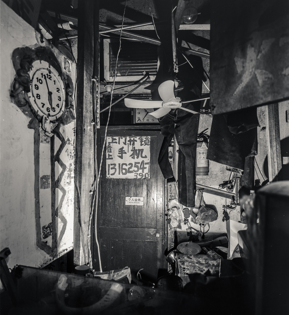 #50 I managed to lean all the way in and take a shot of GodKnowsWhatThisIs. Not even the clock on the wall shows the right time. According to the sign this is a Retail Bank. No really, check the door!