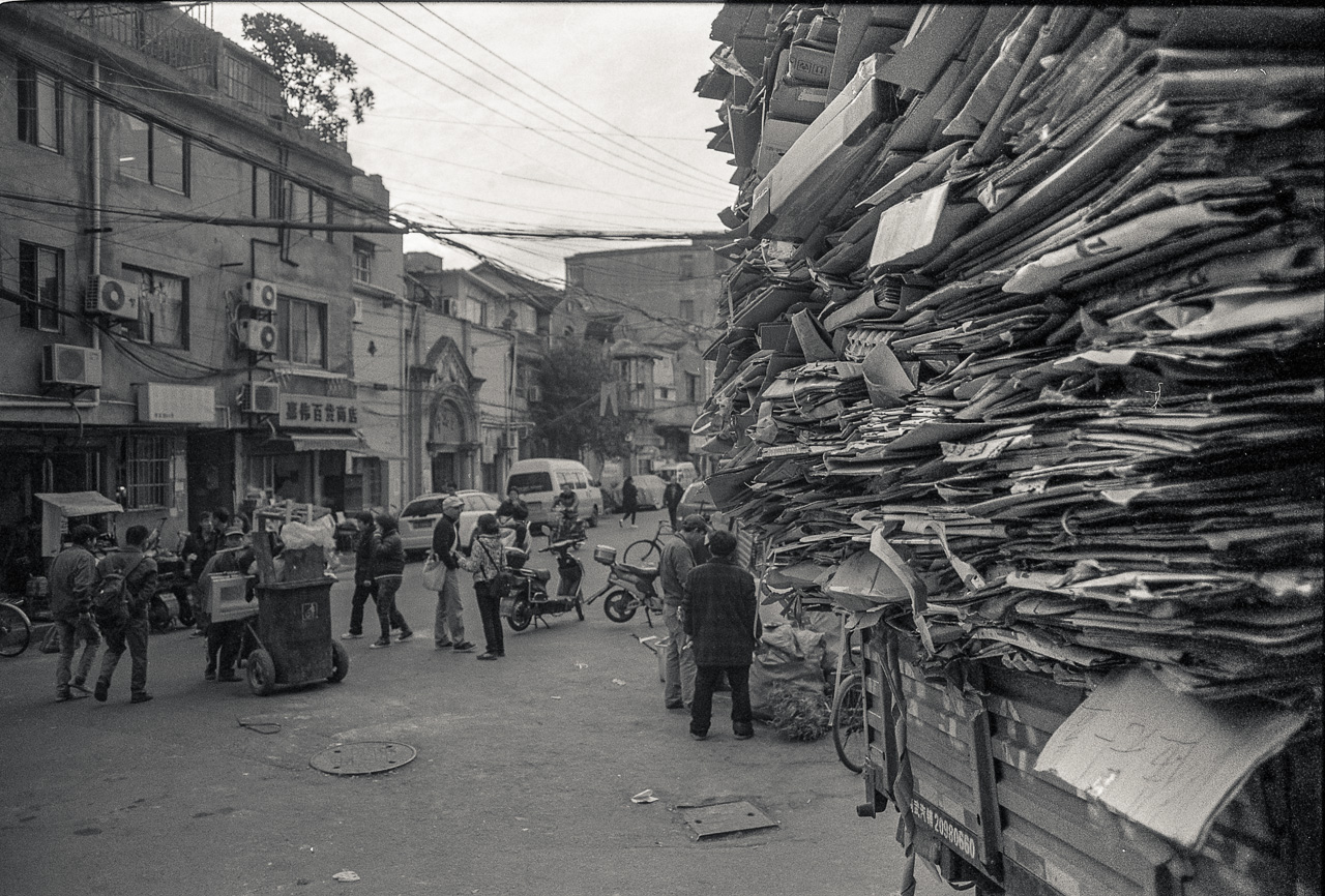 #9 walking further into Laoximen - the good old roadside stack of cardboard.